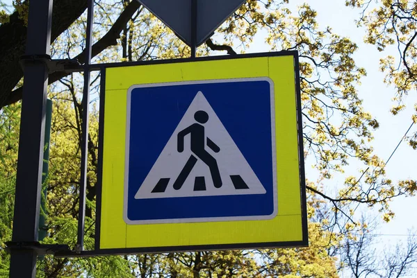 Sign of a pedestrian crossing on the street.