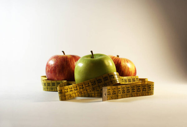 Apples and tape for measuring body volume, diet.