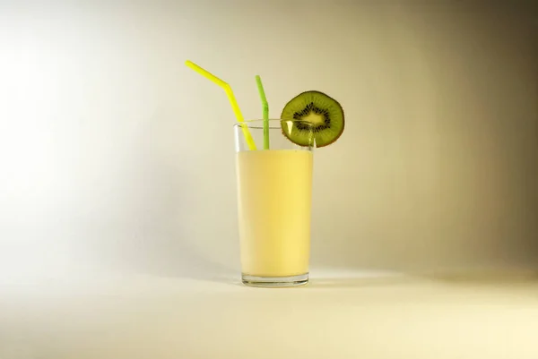 Juicy kiwi and healthy drink with a straw