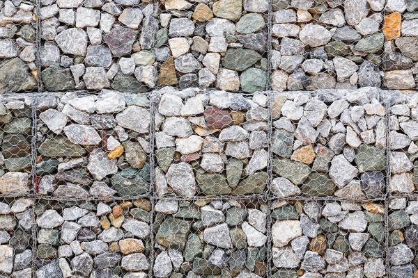 Stone wall with wire mesh — Stock Photo, Image