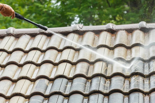 Roof cleaning with high pressure water cleaner