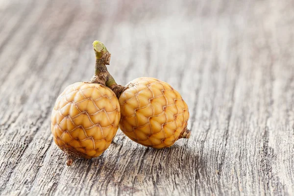 Rattan fruit on wooden table — Stock Photo, Image