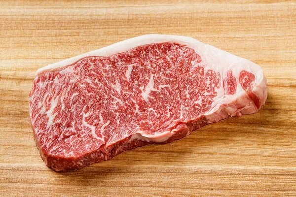 关闭了神户牛排 Striploin 在砧板上 — 图库照片