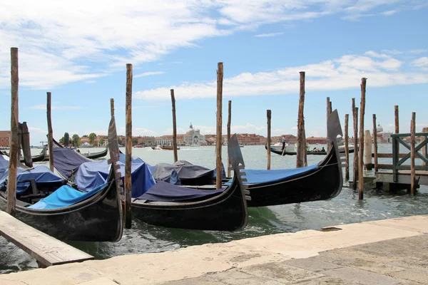 Venetian landscape with gondolas and mooring piles. — Stock Photo, Image