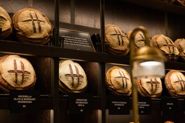 LONDON, UK - FEBRUARY 20, 2020: Fresh baked bread on the shelves of Fresh market store in Harrods shopping mall.