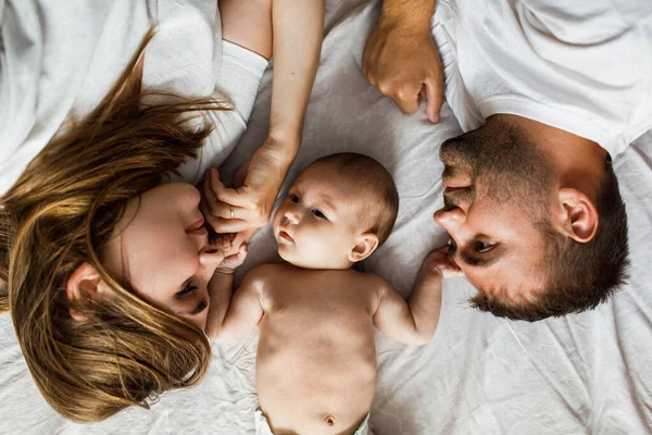 Young Attractive Happy Parents Lying Bed Upside Little Baby Looking — Stock Photo, Image
