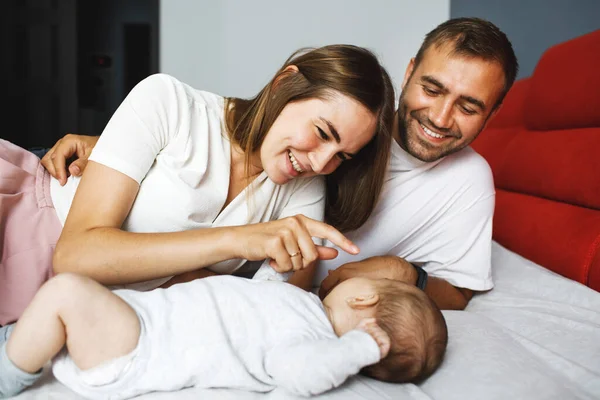 Young Happy Parents Home Lying Bed Looking Little Baby Talking — Stock Photo, Image