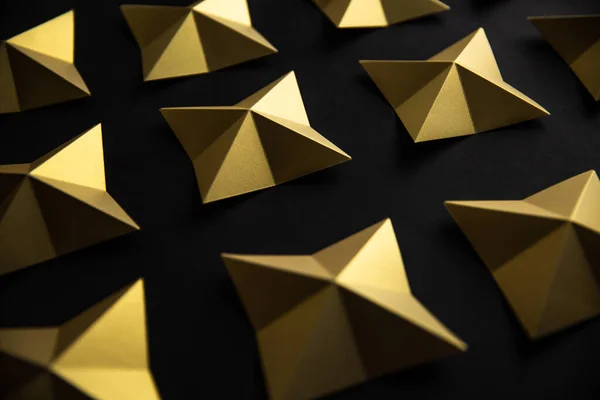 Luxury geometric gold stars on black paper background pattern. 3D shiny rich old classic wallpaper design.