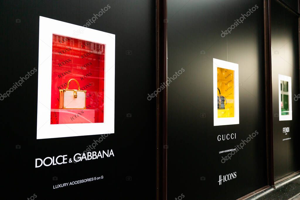 LONDON, UK - FEBRUARY 20, 2020: Dolce and Gabbana, Gucci, Fendi ladies purses on window showcase of famous Harrods shopping mall.