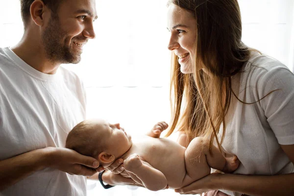 Young Happy Cheerful Parents Wearing White Shirts Holding Little Baby — Stock Photo, Image