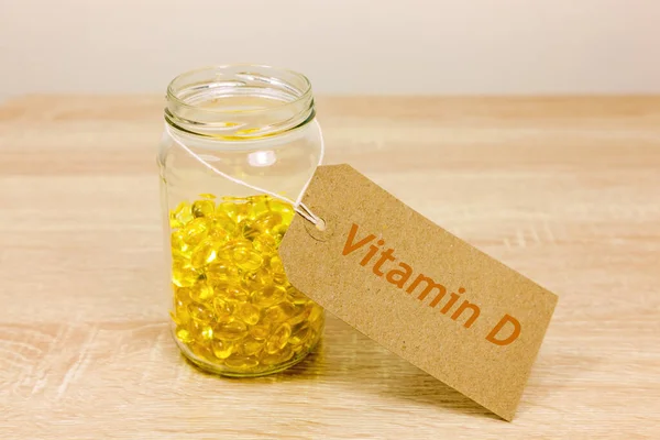 Glass jar full of vitamin D capsules and label that reads \'Vitamin D\'