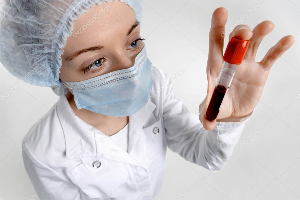 Isolated scientist on a white background analyzes a test tube with a blood sample. New epidemic Coronavirus 2019-nCoV