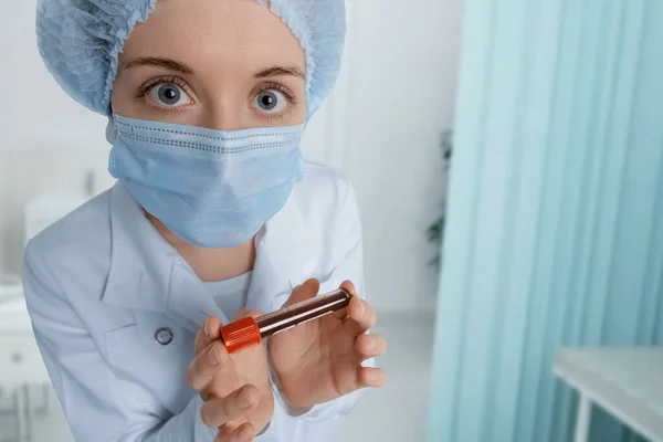 Il dottore con un campione di sangue ti guarda con paura. Concetto di quarantena del coronavirus, MERS Wuhan, Cina . Foto Stock