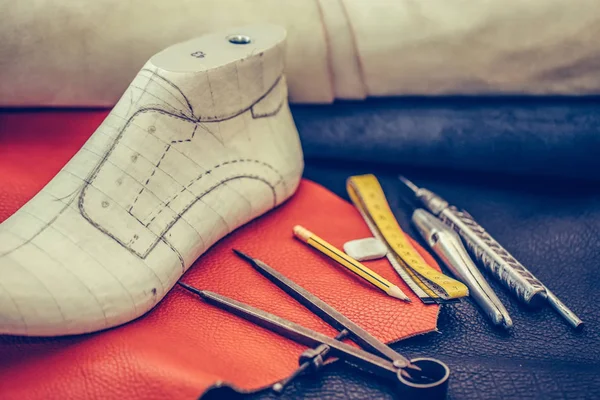 Lugar de trabajo del zapatero con herramientas, cuero y zapatos — Foto de Stock