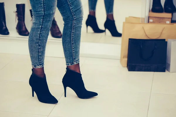 Žena se snaží na nové boty s vysokými podpatky při pohledu — Stock fotografie