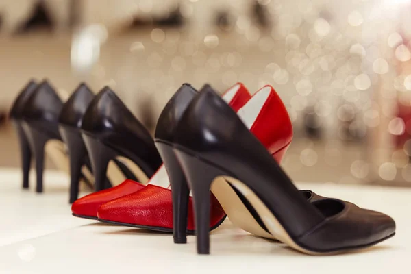 Collection of high-heels leather shoes standing in a row on a sh