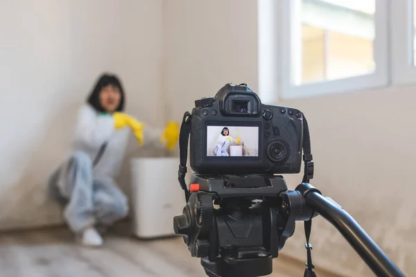 Video camera filming how woman using dehumidifier cleaning and drying air next to a bad mold and fungus growth on an interior wall. Purifier for spores and particles in a toxic environment.