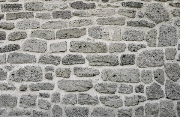 Das Mauerwerk einer alten Steinmauer erodierte. Nahaufnahme — Stockfoto