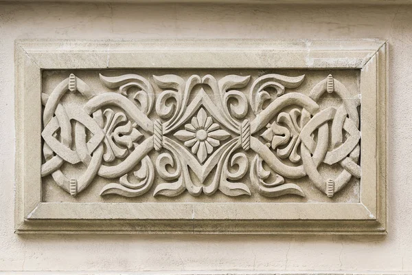 Decorative stone, carved panel for wall decoration.