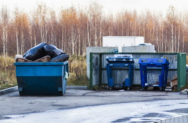 Garbage containers in full with garbage. Garbage containers used for collecting solid household waste.