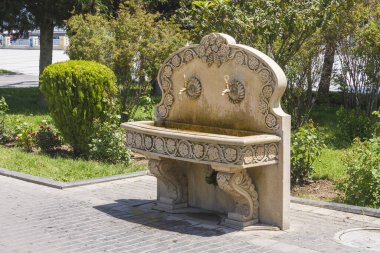 Water-collecting tap for distribution of free drinking water installed in the seaside city Park. The crane is made in Oriental style from carved stone. Baku, Azerbaijan.