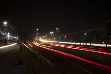 Otobanda hız trafik ışıkları, uzun pozlama, kentsel arka plan ve karanlık gökyüzü