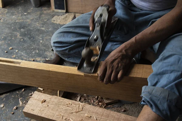 Carpenter working with gouge on table in his workshop — Stock Photo, Image