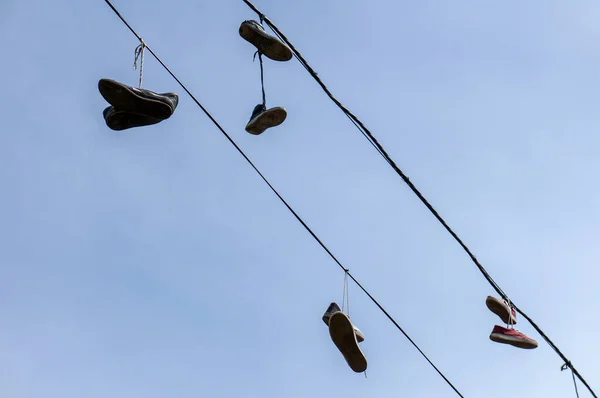 Σιλουέτες Παπουτσιών Που Κρέμονται Στο Καλώδιο Στο Ηλιοβασίλεμα — Φωτογραφία Αρχείου