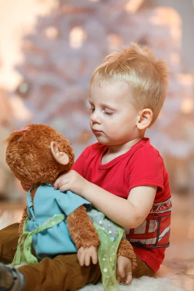 Cute blonde hair little boy with his favorite toy.