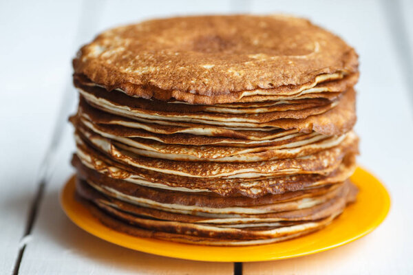 High stack of cooked classic pancakes. Traditional for pancake week Maslenitsa