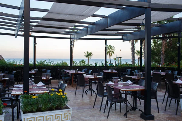 Restaurant with empty served tables and ocean view