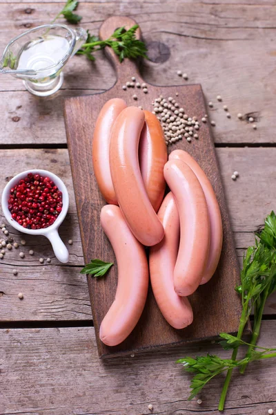 Sausages on board  with herb and spices — Stock Photo, Image