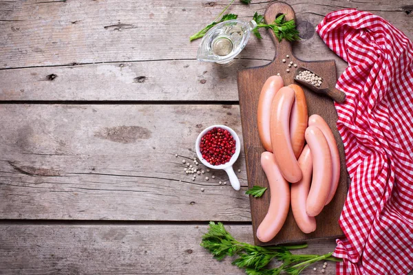 Sausages on board  with herb and spices — Stock Photo, Image