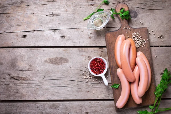 Sausages on board  with herb and spices — Stock Photo, Image