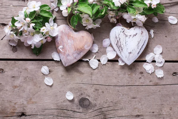 decorative hearts and apple flowers  on vintage wooden