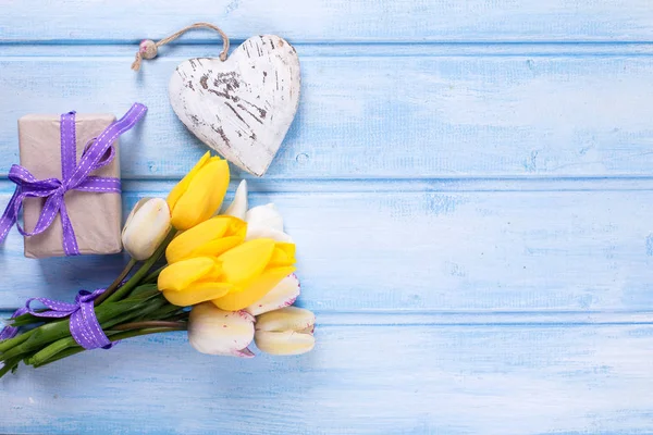 Spring tulips, wrapped  present and decorative heart — Stock Photo, Image