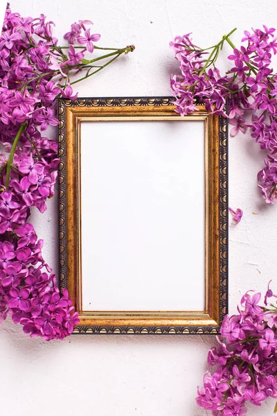 Fresh lilac flowers and empty frame — Stock Photo, Image