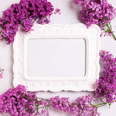 Taze leylak çiçekler ve boş beyaz bir çerçeve