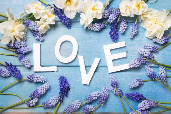 Word love and  blue and white flowers