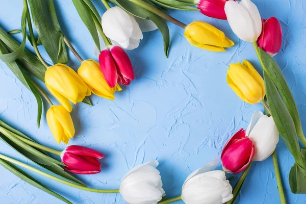 Frame from bright flowers on blue backgtround. — Stock Photo, Image