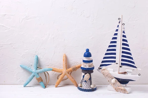 Decorative boats, lighthouse and starfishes — Stock Photo, Image