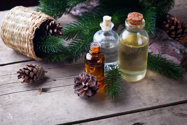 Bottles with fir tree essential aroma oil — Stock Photo, Image