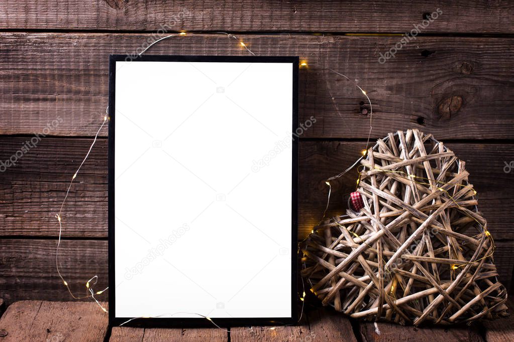 Empty  black frame and decorative heart 