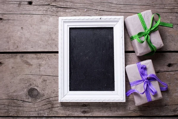 Empty blackboard and  festive gift boxes — Stock Photo, Image