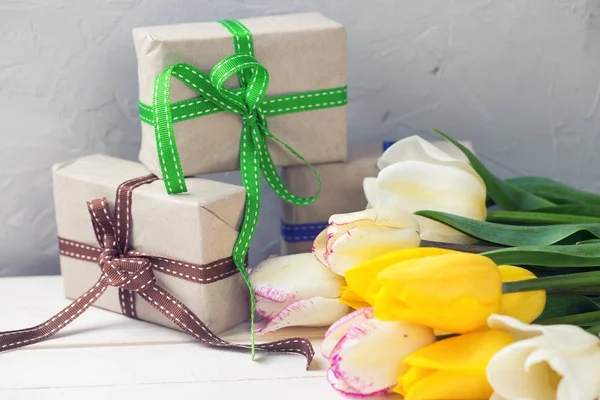 Tulips and wrapped  boxes — Stock Photo, Image