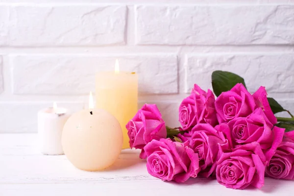 Bunch Pink Roses Flowers Three Burning Candles White Wooden Background — Stock Photo, Image