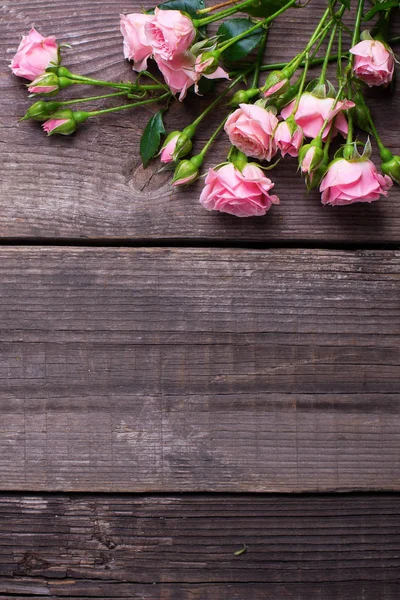 从嫩粉红色玫瑰花在老式的木质背景 花静物 顶部视图 选择性对焦 文本的位置 垂直图像 — 图库照片