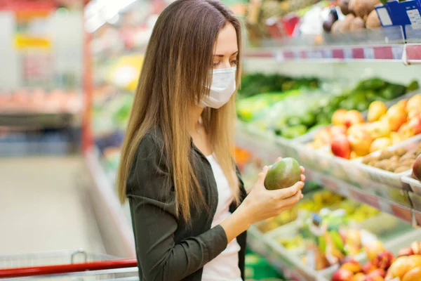 Woman in medical mask shopping in supermarket.