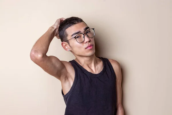 Young sexy man in glasses posing and looking at camera — Stock Photo, Image