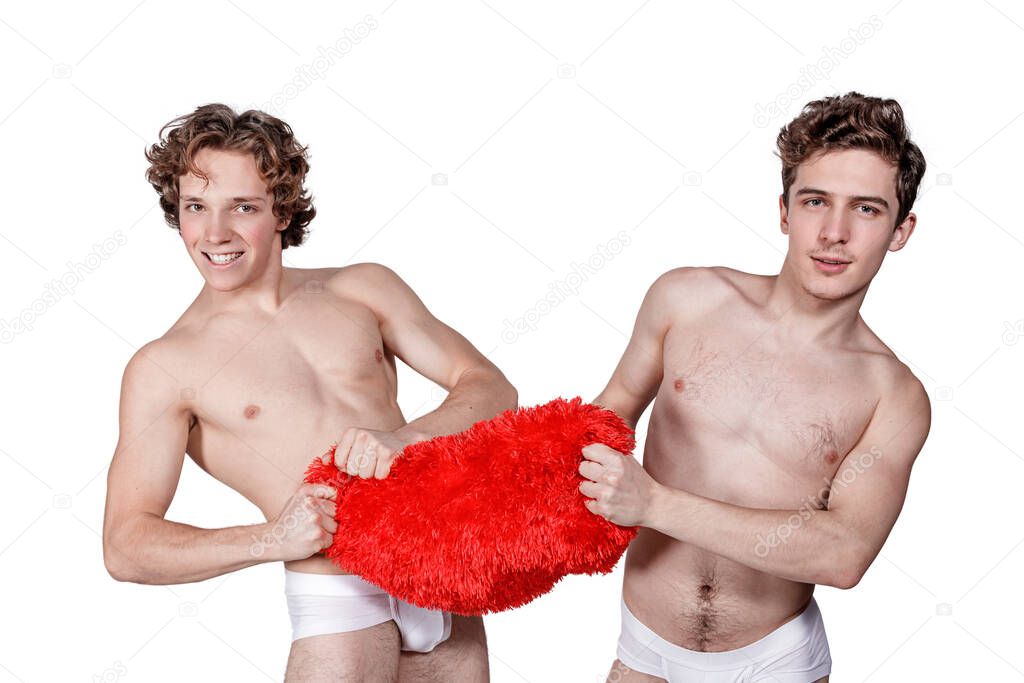 Two naked guys pull a big red heart in different directions on white background